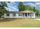 Charming one-story home features green shutters and a welcoming front porch and yard at 43 Columbus Ct, Spring Lake, NC 28390