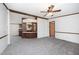 Cozy living space featuring a ceiling fan, neutral carpet, and views of kitchen features at 43 Columbus Ct, Spring Lake, NC 28390