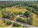 Scenic aerial perspective of a home with a large lot, trees, and roadside access at 4314 Hopkins Rd, Middlesex, NC 27557