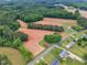 Aerial view of a property with fields, a small building, and surrounding trees at 4314 Hopkins Rd, Middlesex, NC 27557