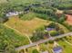 Aerial view featuring a home on a large lot, near the road, with a picturesque pond at 4314 Hopkins Rd, Middlesex, NC 27557