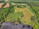 Aerial view of a property featuring a pond, fields, and surrounding trees at 4314 Hopkins Rd, Middlesex, NC 27557