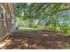Shady backyard with mature trees and leaf covered ground at 4314 Hopkins Rd, Middlesex, NC 27557