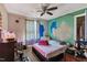 The bedroom is brightly lit with unique wall paintings and a ceiling fan at 4314 Hopkins Rd, Middlesex, NC 27557