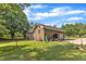 Brick house with a 2-car garage, lawn, and a variety of landscaping features at 4314 Hopkins Rd, Middlesex, NC 27557