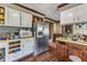 This kitchen features a stainless steel refrigerator, white cabinets, and a microwave at 4314 Hopkins Rd, Middlesex, NC 27557