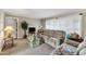 This living room has large windows, neutral walls, carpet flooring, and a comfortable couch at 4314 Hopkins Rd, Middlesex, NC 27557