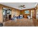 The living room has wooden walls and features a view into the kitchen at 4314 Hopkins Rd, Middlesex, NC 27557