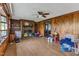 Spacious living room with hardwood floors, a brick fireplace, and wood paneled walls at 4314 Hopkins Rd, Middlesex, NC 27557