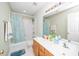 Clean bathroom with a double sink vanity, well-lit mirror, and a shower-tub combination with a light blue curtain at 437 New Parkside Dr, Chapel Hill, NC 27516