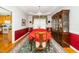 Elegant dining room with a beautiful wooden china cabinet, chandelier, and a long table set with a red tablecloth at 437 New Parkside Dr, Chapel Hill, NC 27516