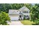 Charming two-story home features a two-car garage, landscaped yard, and welcoming front porch at 437 New Parkside Dr, Chapel Hill, NC 27516