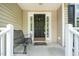 Inviting front porch with detailed sidelights, a bench, and ample space for relaxing at 437 New Parkside Dr, Chapel Hill, NC 27516
