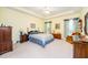 Spacious bedroom with a tray ceiling, ceiling fan, and blue floral bedding, creating a calming retreat at 437 New Parkside Dr, Chapel Hill, NC 27516