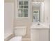 This bathroom features a white vanity, toilet, and shower at 4621 Worthington Ln, Raleigh, NC 27604