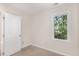 This bedroom features neutral walls, carpet, and a window with outdoor views at 4621 Worthington Ln, Raleigh, NC 27604