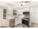 Bright kitchen with stainless steel appliances, white cabinets, and a modern design at 4621 Worthington Ln, Raleigh, NC 27604