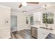 Kitchen featuring stainless steel appliances, white cabinets, and vinyl flooring at 4621 Worthington Ln, Raleigh, NC 27604