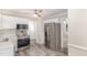 Kitchen with stainless appliances, ceiling fan, and ample cabinet space at 4621 Worthington Ln, Raleigh, NC 27604