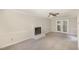 Living room with neutral walls, fireplace, carpet, and french doors to the back at 4621 Worthington Ln, Raleigh, NC 27604