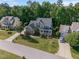 Exterior elevation of house showing mature trees and a well-manicured lawn at 5117 Dove Forest Ln, Apex, NC 27539