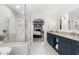 This elegant bathroom features a walk-in shower, soaking tub, and double vanity sinks at 5117 Dove Forest Ln, Apex, NC 27539