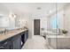The modern bathroom offers a soaking tub, a walk-in shower, and double sink vanity at 5117 Dove Forest Ln, Apex, NC 27539