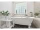 Relax in this bathroom's soaking tub, which has a window view, or enjoy the tiled shower at 5117 Dove Forest Ln, Apex, NC 27539