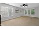 Bright bedroom with neutral walls, carpet, ceiling fan and two windows at 5117 Dove Forest Ln, Apex, NC 27539