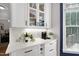 Convenient butler's pantry features sleek cabinets, a countertop, and a wine rack, ideal for entertaining at 5117 Dove Forest Ln, Apex, NC 27539