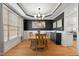 Formal dining room features hardwood floors, wainscoting, modern chandelier, and a large window at 5117 Dove Forest Ln, Apex, NC 27539
