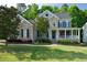 Charming two-story home featuring stone accents, a welcoming front porch, and a beautifully landscaped front yard at 5117 Dove Forest Ln, Apex, NC 27539