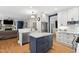 Spacious kitchen with island and stainless steel appliances open to the living area at 5117 Dove Forest Ln, Apex, NC 27539