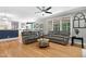 Spacious living room with hardwood floors, neutral paint, large windows, and comfortable seating at 5117 Dove Forest Ln, Apex, NC 27539
