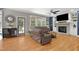 Cozy living room featuring a fireplace, built-in shelving, and a comfortable seating area at 5117 Dove Forest Ln, Apex, NC 27539