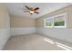 Empty bedroom with carpeted floors, white wainscotting and a large window at 515 Tramway West Rd, Sanford, NC 27330