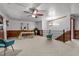 Bright bonus room features wood-paneled walls, carpeted floors, and a ceiling fan at 515 Tramway West Rd, Sanford, NC 27330