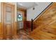 Warm entryway with wooden accents, showcasing a charming door and staircase leading to the upper levels at 515 Tramway West Rd, Sanford, NC 27330