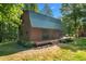 Charming cabin with a metal roof and a backyard deck, perfect for outdoor living at 515 Tramway West Rd, Sanford, NC 27330