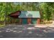 Rustic two-car garage with a covered parking area, set amidst a lush, green environment at 515 Tramway West Rd, Sanford, NC 27330