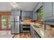 Stylish kitchen with stainless steel appliances, granite counters, and backyard access at 515 Tramway West Rd, Sanford, NC 27330