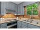 Updated kitchen with granite countertops, stainless steel appliances, and wood paneling at 515 Tramway West Rd, Sanford, NC 27330