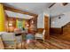 Comfortable living room with wood paneling, hardwood floors, and staircase access at 515 Tramway West Rd, Sanford, NC 27330