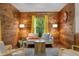 Cozy living room with wood-paneled walls, a comfortable sofa, and bright accents for a warm ambiance at 515 Tramway West Rd, Sanford, NC 27330