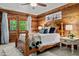 Inviting bedroom with wood accents, ceiling fan, and a view to the outside at 515 Tramway West Rd, Sanford, NC 27330