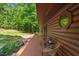 Charming log cabin showcasing a cozy patio with outdoor seating at 515 Tramway West Rd, Sanford, NC 27330