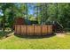 Backyard featuring an above ground pool with stairs to the wooden deck at 515 Tramway West Rd, Sanford, NC 27330