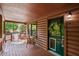 A cozy cabin porch with a yellow flower wreath on the door, creating a welcoming entrance at 515 Tramway West Rd, Sanford, NC 27330