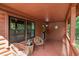 Inviting cabin porch with seating, perfect for enjoying the serene wooded surroundings at 515 Tramway West Rd, Sanford, NC 27330