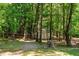 Backyard shed surrounded by mature trees, offering practical storage in a natural setting at 515 Tramway West Rd, Sanford, NC 27330